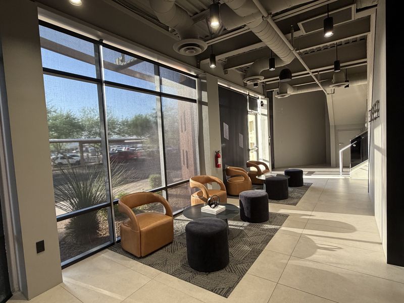 The lounge at CYBER, with desert light through floor-to-ceiling windows